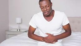 Man clutching his stomach in pain